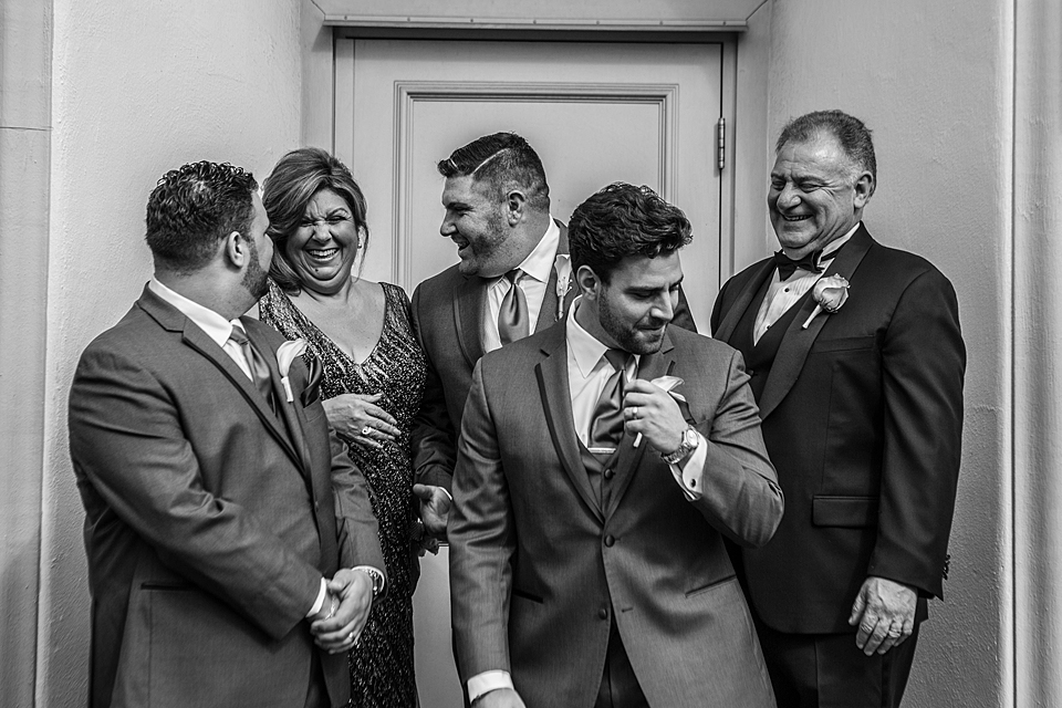groom laughing and having fun with the family before the wedding in vero beach florida