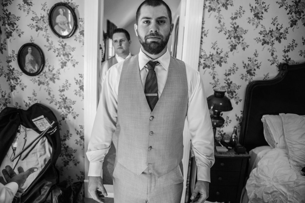 black and white photo of groom hanging out