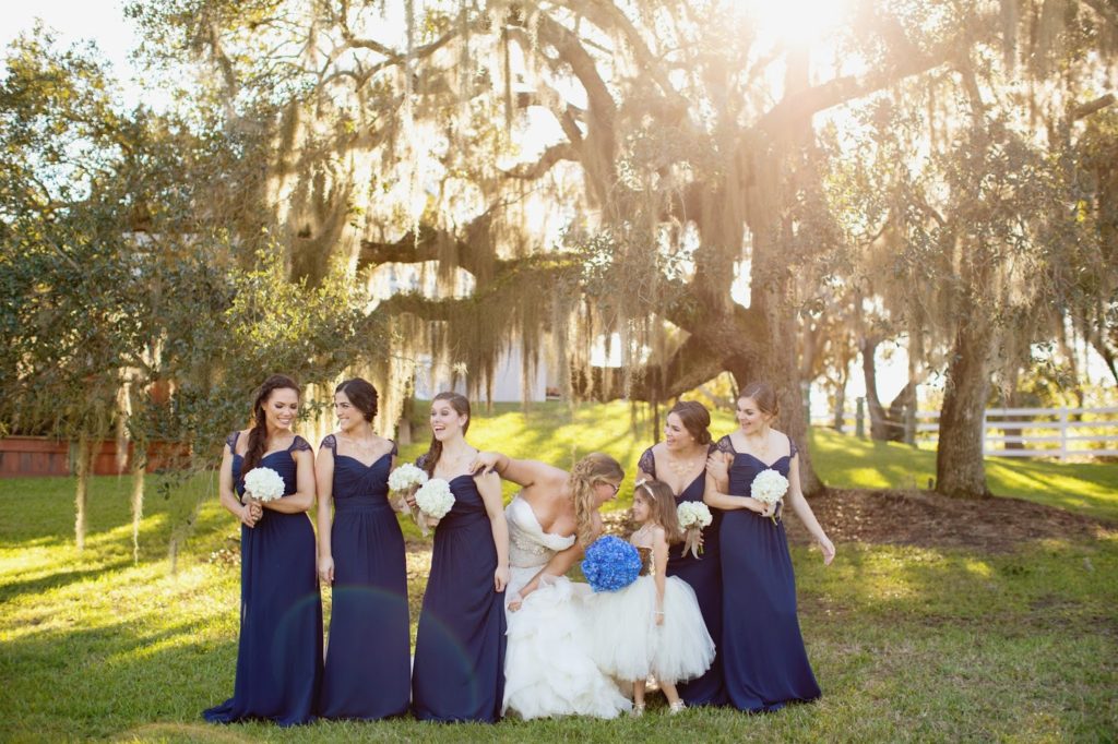 bridesmaids wearing navy and laughing at each other