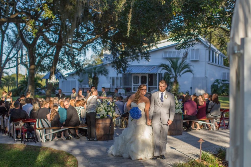 Bride and groom smiling as they exit their ceremony