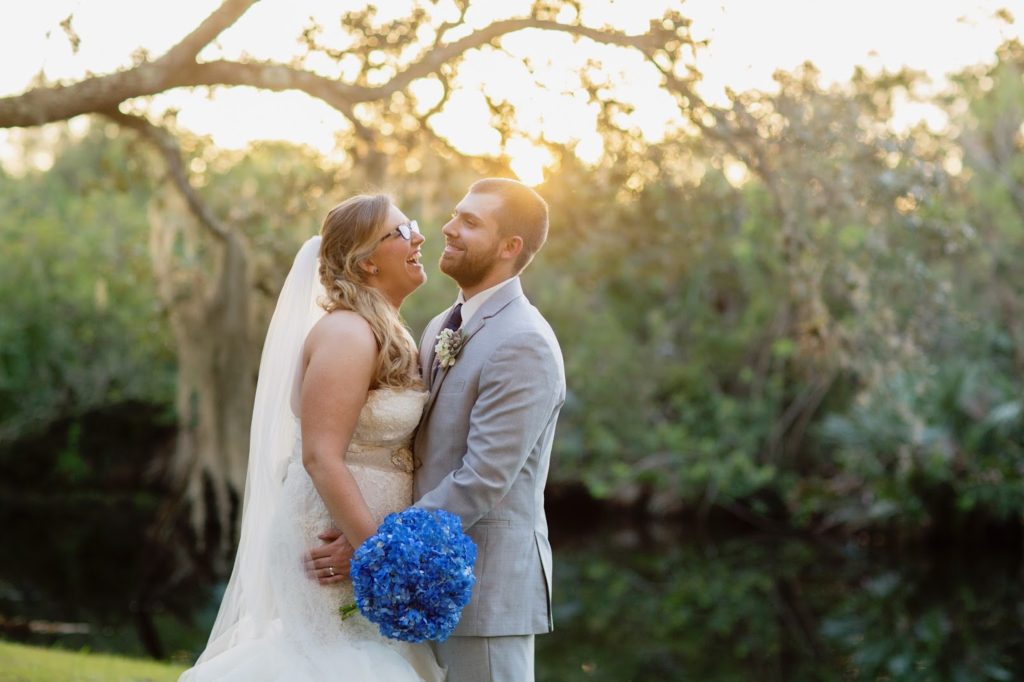 bride and groom with blue bouquet 