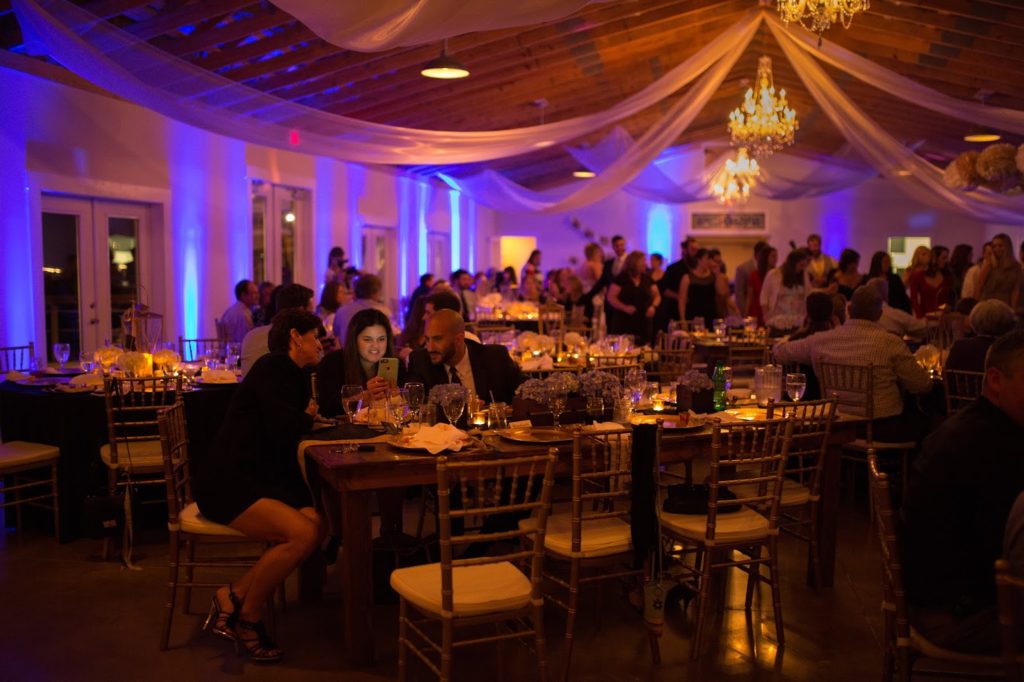 guests playing on their phone while everyone is dancing