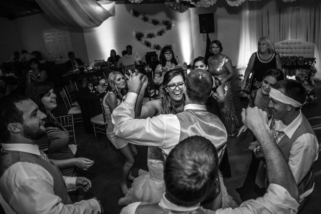 couple surrounded by guests on the dance floor.