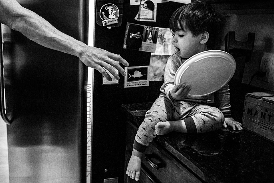 funny photo of dad reaching for toddler 