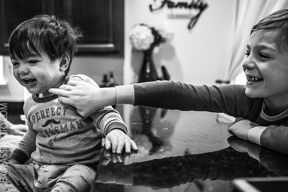 brother tickling each other while still in pajamas