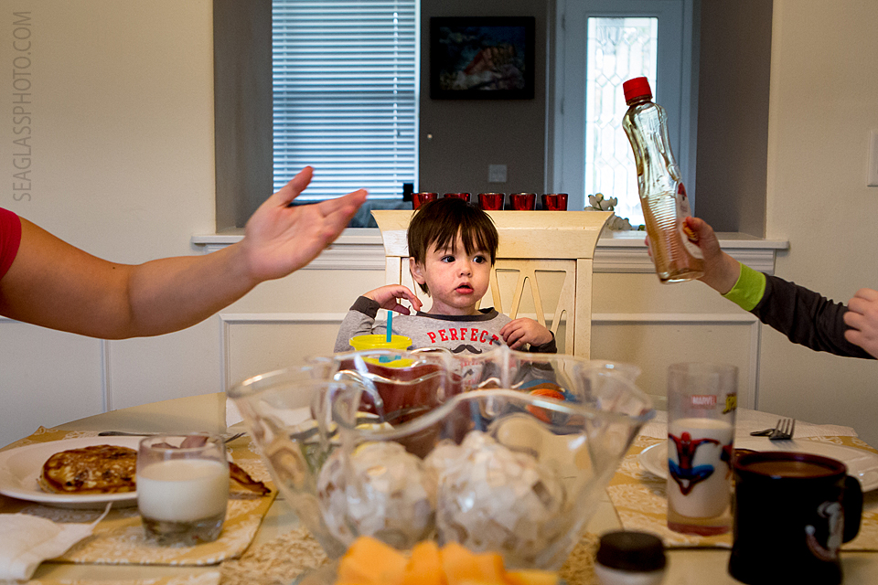 curious toddler wanting the syrup for his pancakes