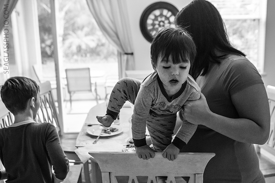 climbing toddler at the dinner table