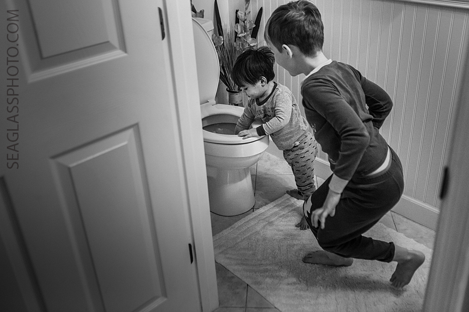 toddler playing in the toliet