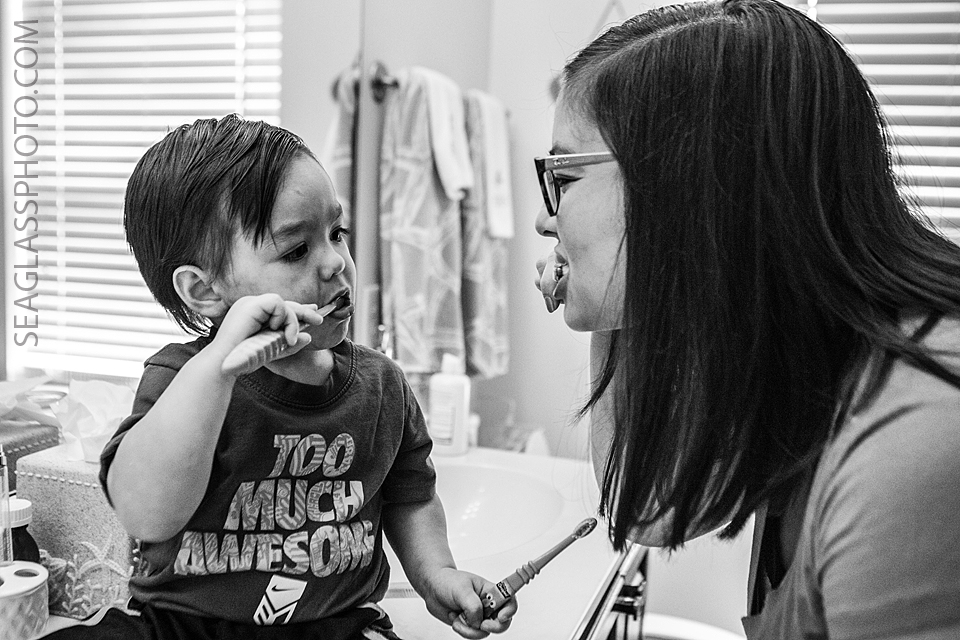 mom and son brushing teeth together