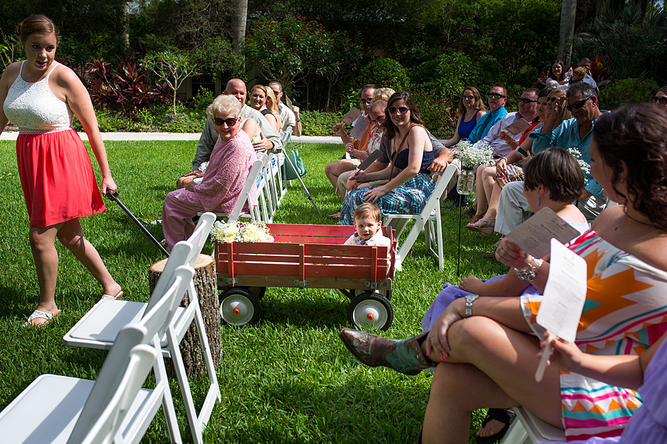 ring bearer at mckee gardens in a red wagon in south florida