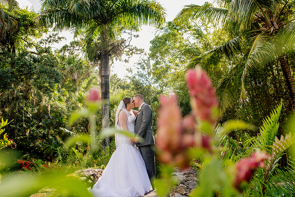Vero Beach florida wedding Bride and groom in a garden kissing
