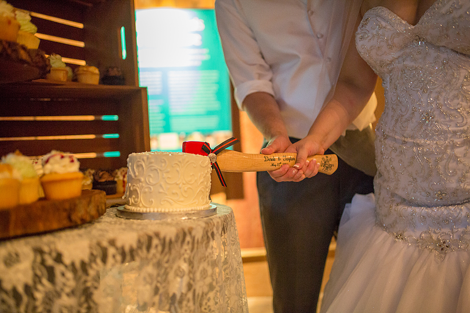 bride and groom cut thier cake with a fire ax at mckee gardens in vero beach florida