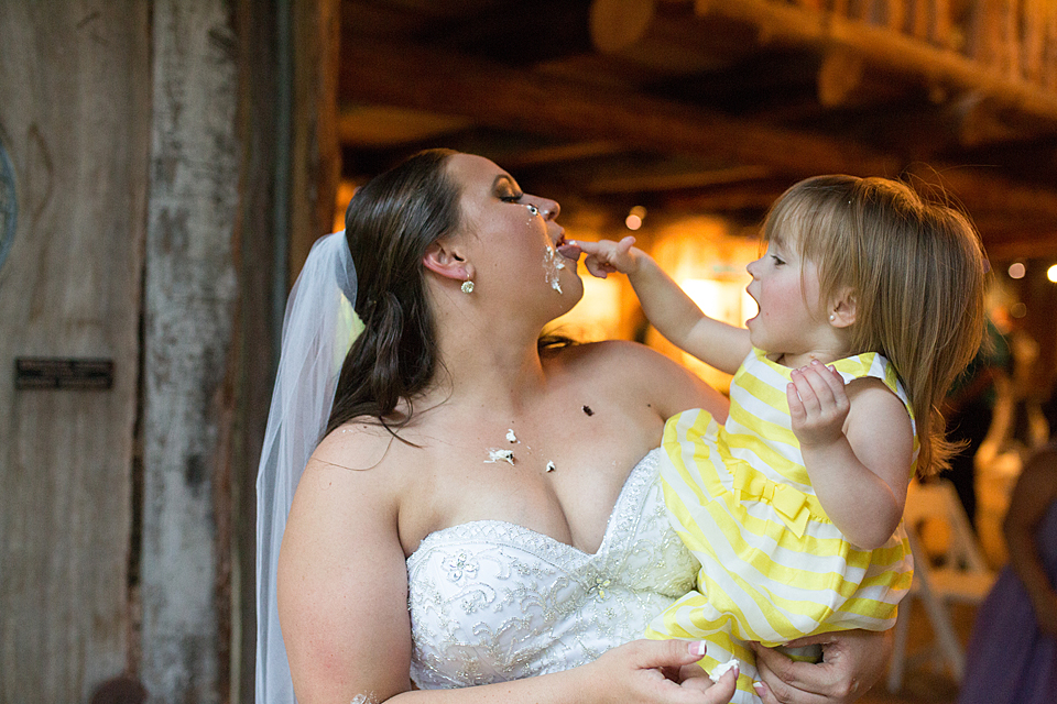 flower girl feeds the bride cake 