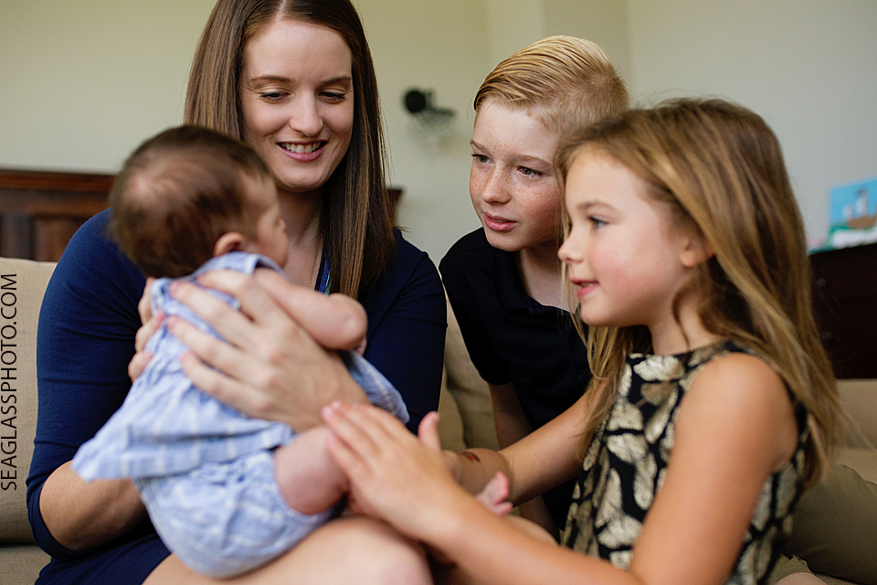 siblings talking to baby sister Newborn Photos in Vero Beach Florida Lifestyle