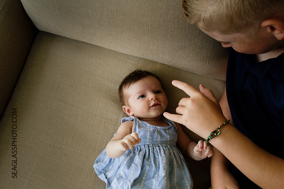big brother talking to newborn baby sister Newborn Photos in Vero Beach Florida Lifestyle