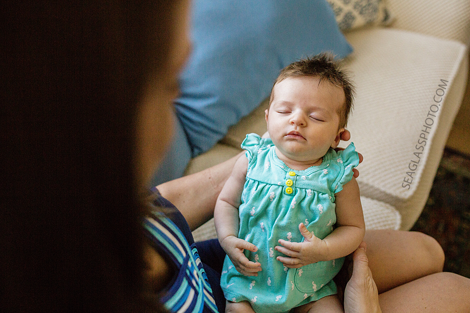 newborn girl sleeping in mom's arms Newborn Photos in Vero Beach Florida Lifestyle