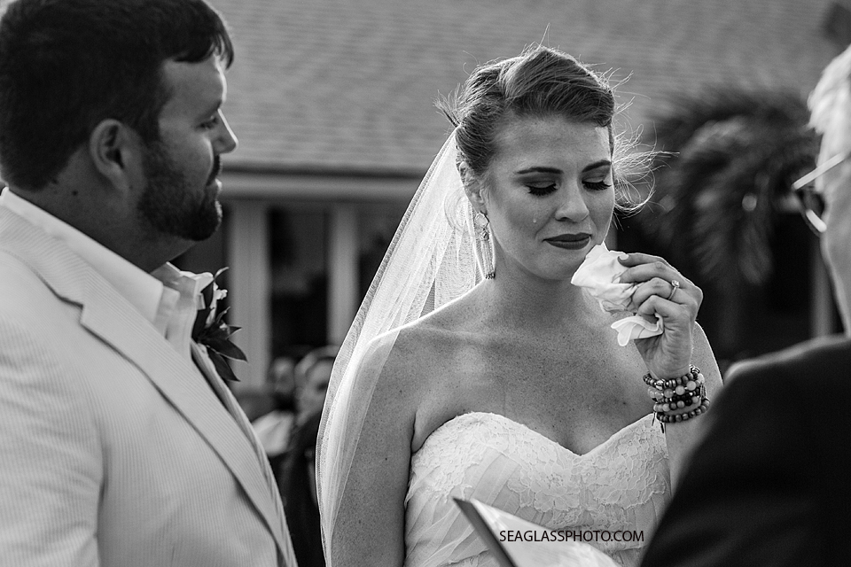 black and white photo of bride crying during wedding vows