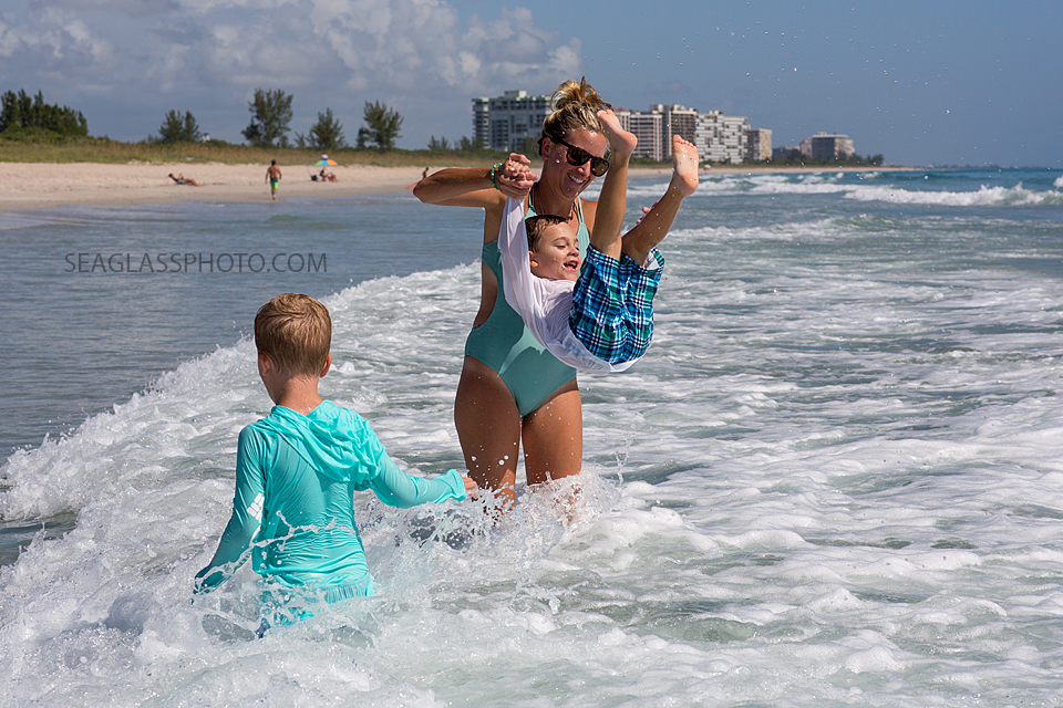 Mom playing with her sons in the ocean at the Ft. Pierce State Park