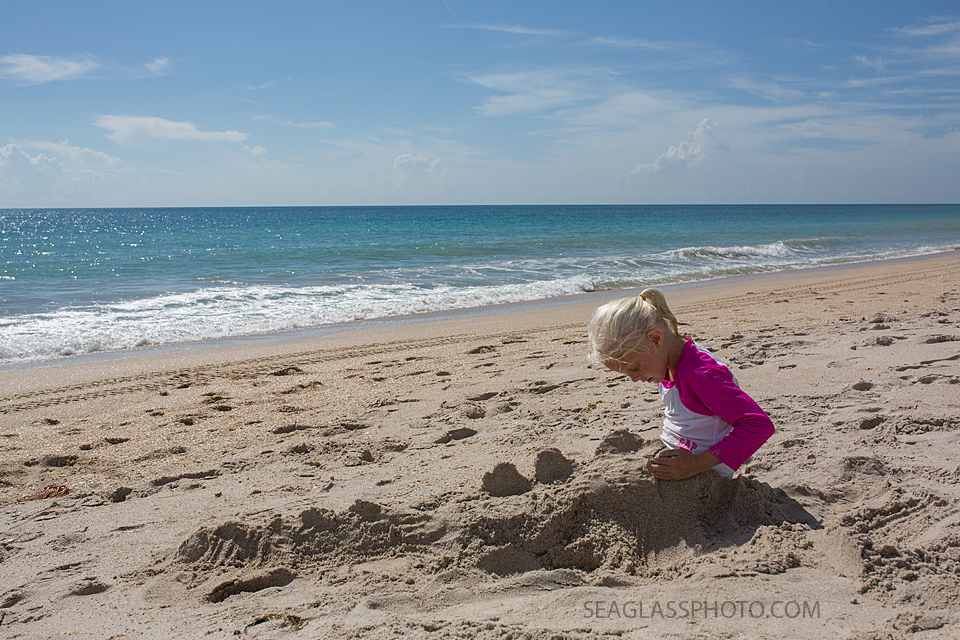 girl playing in the sand in Vero Beach Florida