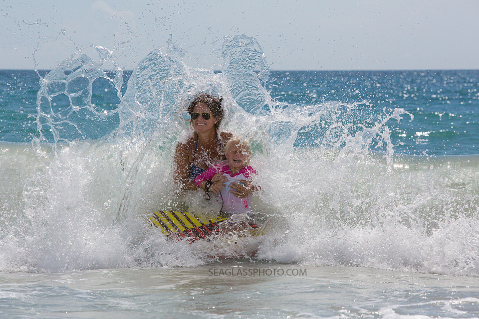 mother and daughter splashed by the waves in Vero Beach Florida