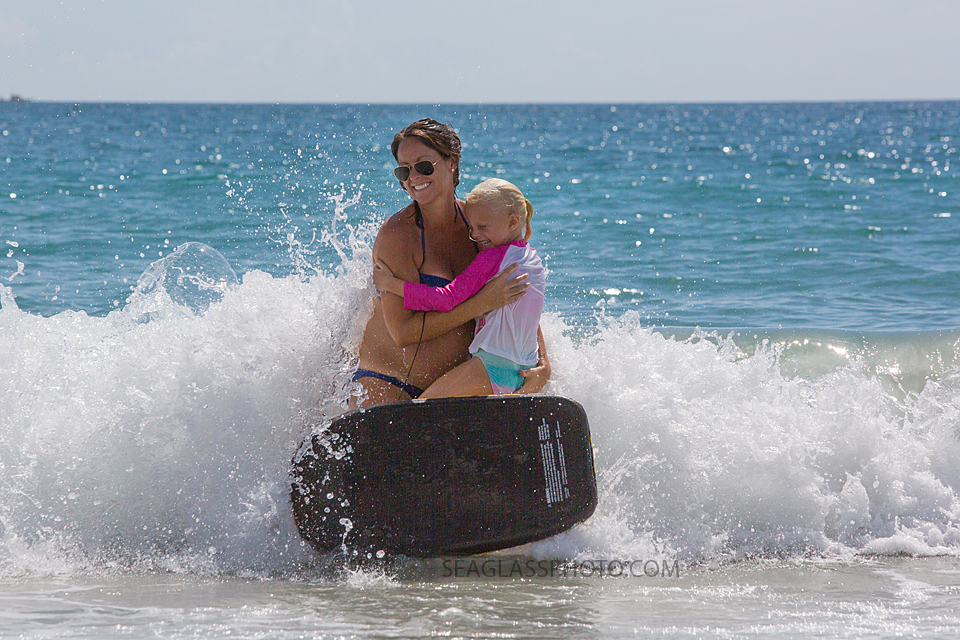 mother and daughter splashed by the waves in Vero Beach Florida