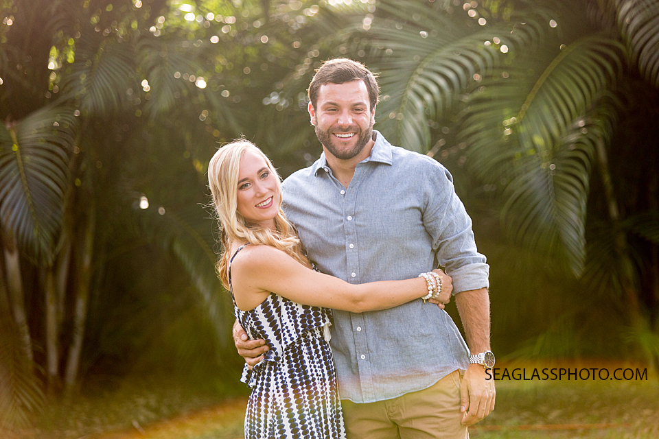 engagement photo with sunflair while she holds onto her fiance in Vero Beach