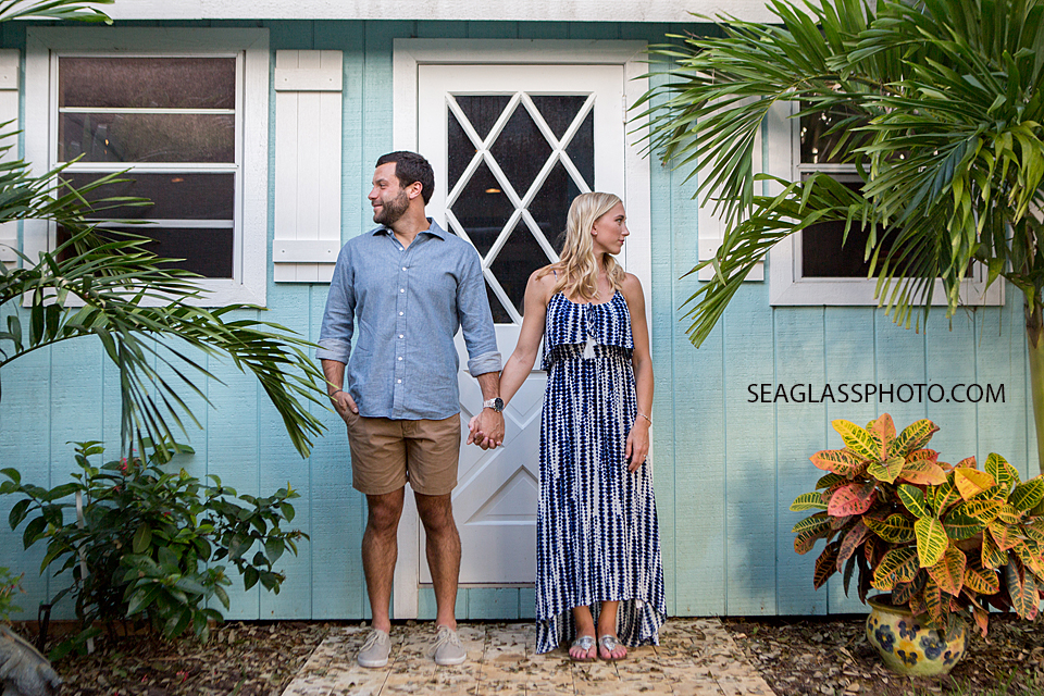 tropical engagement photo of couple holding hands