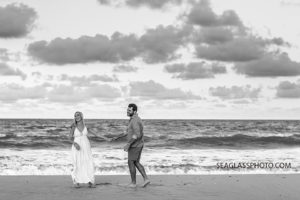 Black and white photo of couple laughing at sunset on the beach in Vero Beach Florida