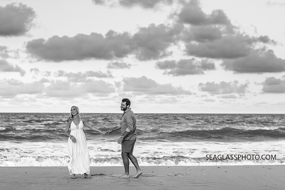 Black and white photo of couple laughing at sunset on the beach in Vero Beach Florida