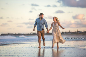 Couple running down the beach at sunset in Vero Beach Florida