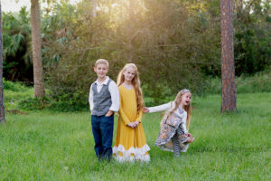 photo of siblings in a field with little girl crying in Vero Beach Florida