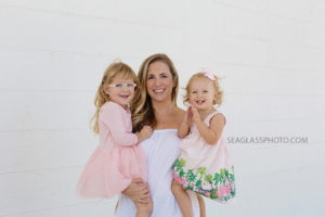 Mother and 2 girls wearing pink and white Family of four at Walking Tree Brewery in Vero Beach Florida