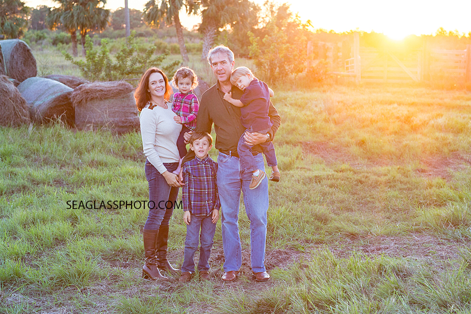 Beautiful family portait of 5 wearing pink, blue and cream at sunset in Vero Beach Florida