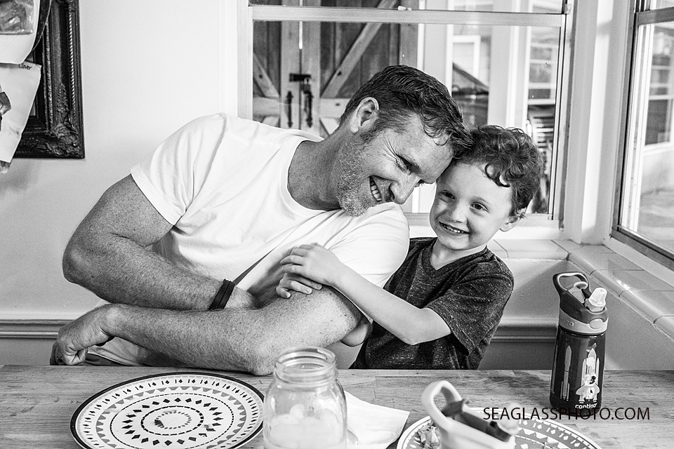 black and white photo of father and son at the kitchen table family documentary vero beach florida