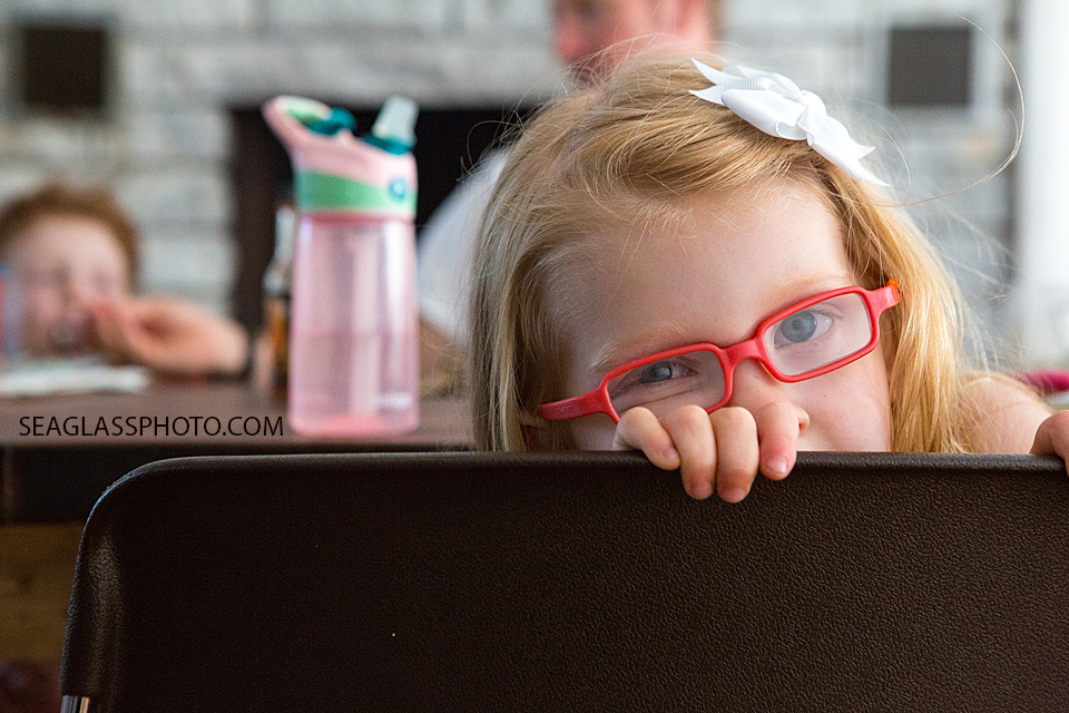 Color photo of little girl sitting at the dinner table with red glasses family documentary vero beach florida