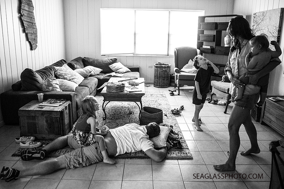 Black and White photo of family at the end of the night hanging out in the living room. family documentary vero beach florida