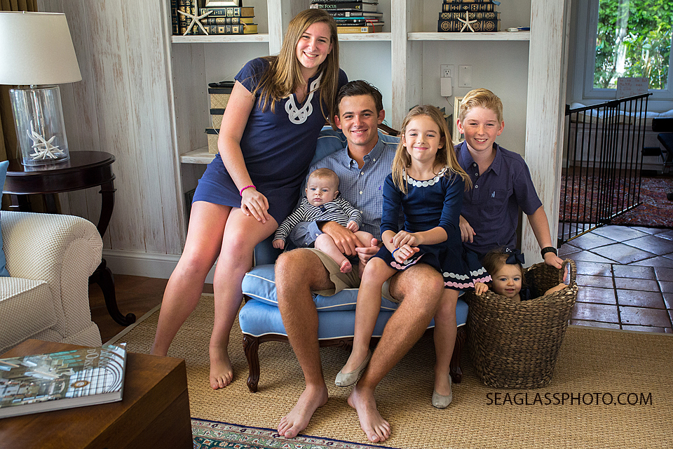 Portrait of siblings all wearing navy blue sitting in a living room in Vero Beach Florida family photography