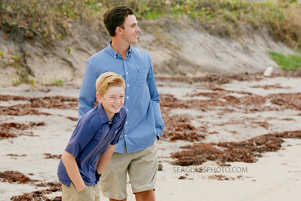 brothers wearing blue, navy and khaki on the beach laughing Vero Beach Florida family photography