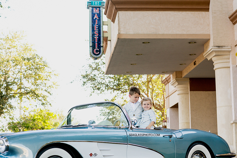 Vero Beach Florida family Photography brother and sister in an antique car in front of Majestic Therater