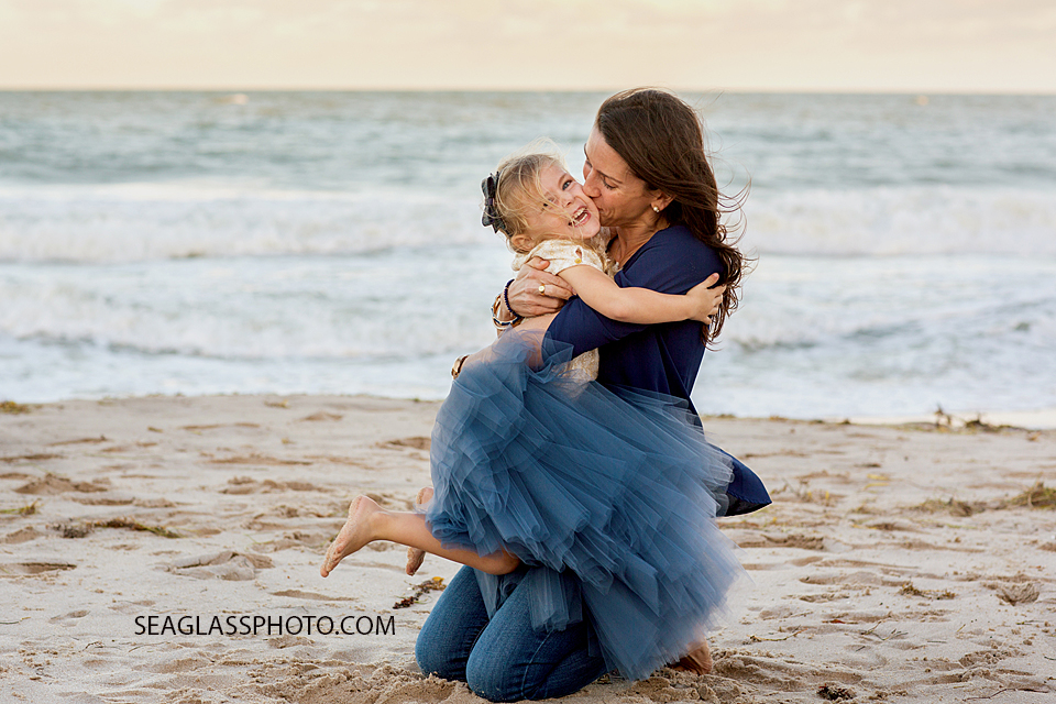 mother and daughter hugging on the beach wearing a navy tutu by Wrare Doll Vero Beach Florida family Photography