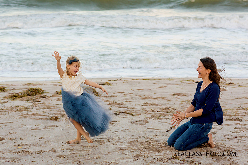 mother and daughter on the beach dancing in a navy tutu by Wrare Doll Vero Beach Florida family Photography