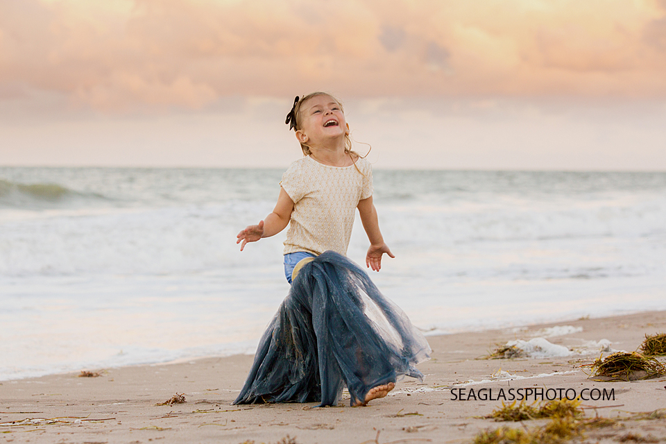 Hysterical photo of little girl in Wrare Doll tutu on the beach Vero Beach Florida family Photography