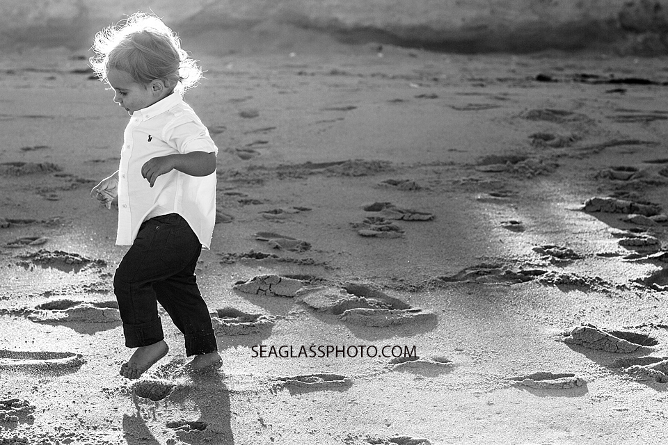 Toddler boy wearing white shirts and jeans Orchid Island Beach Club in Vero Beach Florida