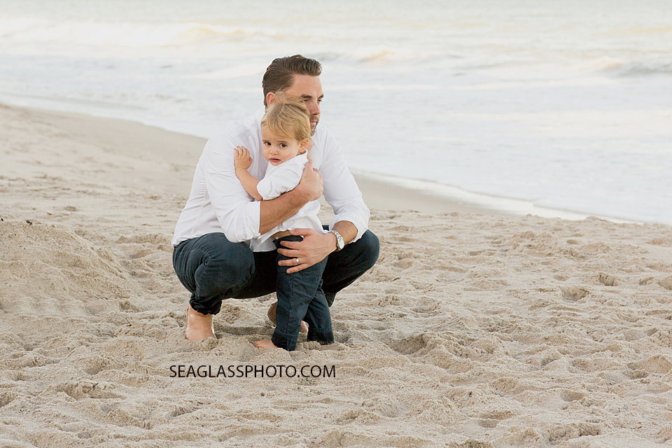 Little boy hugging onto his dad Orchid Island Beach Club in Vero Beach Florida