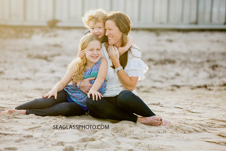 mother with children sitting on the sand n Vero Beach Florida Family Photographer