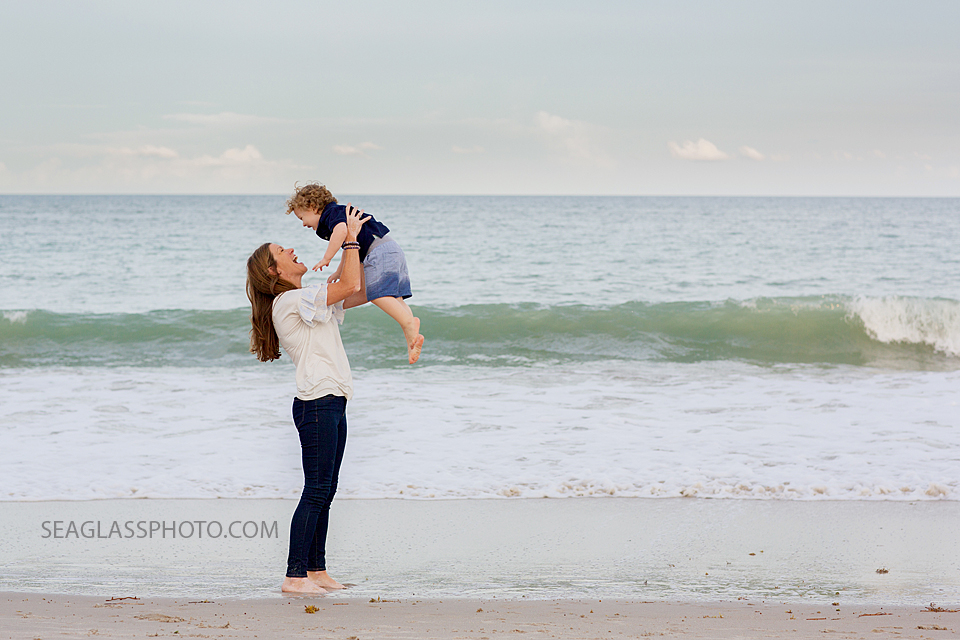 mother holding up her son at the beach n Vero Beach Florida Family Photographer
