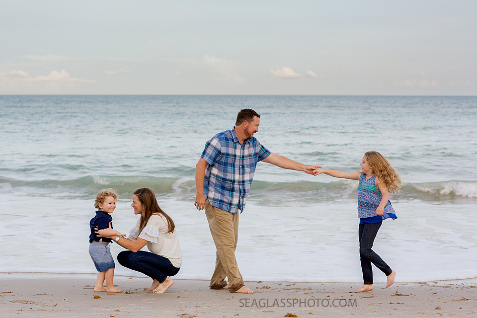 family wearing blue and white at the beach at sunset n Vero Beach Florida Family Photographer
