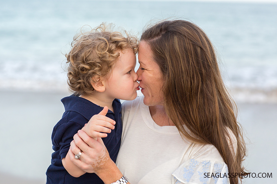 sweet kisses from son to mom wearing blue and white n Vero Beach Florida Family Photographer