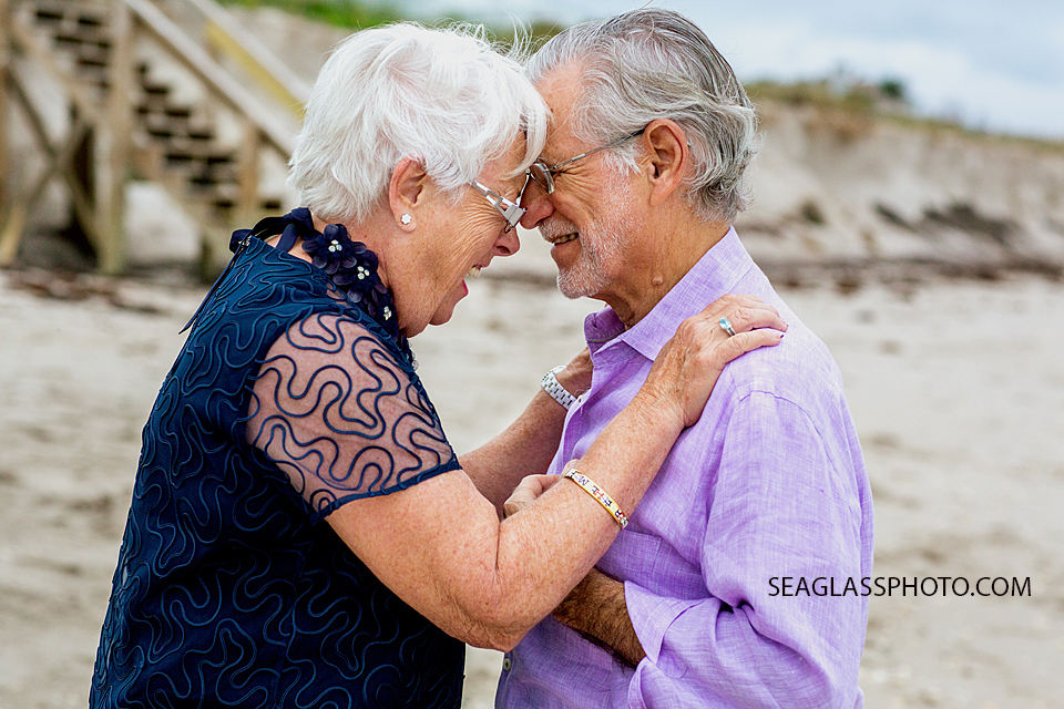 Elderly husband and wife in embrace on the beach at Windsor Beach Club in Vero Beach Florida