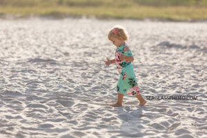 Young girl explores the beach during family photos in Vero Beach Florida